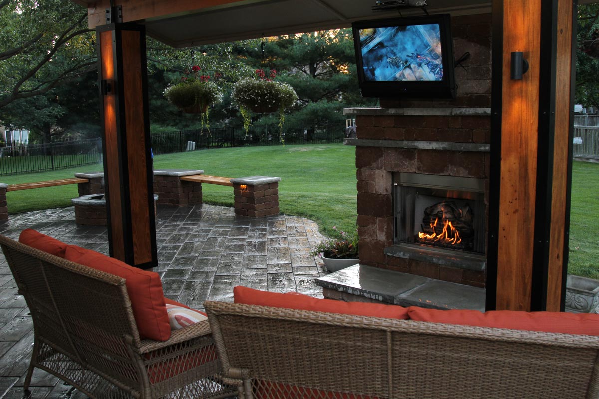 A fireplace with a big screen TV over the mantel.