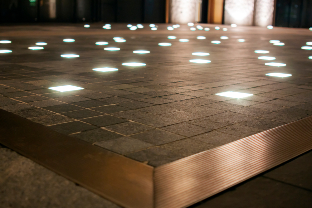 a metal paver patio with inset lights