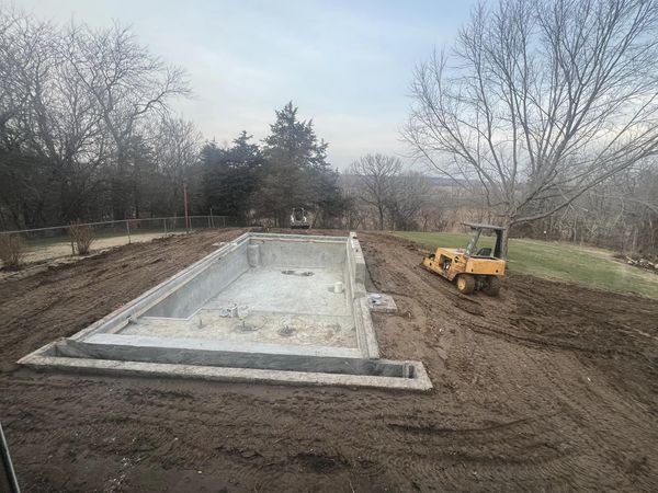 An empty concrete pool in the ground